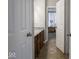 Bathroom with a double vanity, granite countertops, and access to a bedroom through a white paneled door at 9831 N Port Dr, McCordsville, IN 46055