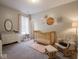 Charming Bedroom with a wooden crib, glider chair, and soft carpet, creating a warm and inviting space at 9831 N Port Dr, McCordsville, IN 46055