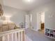 Bright Bedroom offering a wooden crib, shelving, and plush carpet flooring, designed for comfort and functionality at 9831 N Port Dr, McCordsville, IN 46055