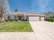 Inviting single-story brick home with a neatly maintained lawn and a wide driveway at 9831 N Port Dr, McCordsville, IN 46055