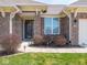 Classic brick facade complemented by manicured shrubs and an inviting front entrance at 9831 N Port Dr, McCordsville, IN 46055