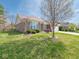 Attractive brick home boasting a lush green lawn and professionally designed landscaping at 9831 N Port Dr, McCordsville, IN 46055