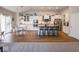 Bright kitchen with white cabinets, stainless steel appliances, and island with bar seating and adjacent dining area at 9831 N Port Dr, McCordsville, IN 46055