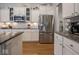This kitchen features stainless steel appliances, granite countertops, and white cabinets at 9831 N Port Dr, McCordsville, IN 46055