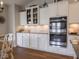 This kitchen features a stainless steel oven, granite countertops, and white cabinets at 9831 N Port Dr, McCordsville, IN 46055