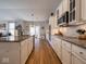 This kitchen features an island, stainless steel appliances, and a view into the living room at 9831 N Port Dr, McCordsville, IN 46055