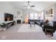 Bright living room showcases a fireplace, TV, comfortable seating, and ample natural light at 9831 N Port Dr, McCordsville, IN 46055