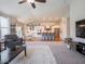 Open layout shows living room flowing into the kitchen with an island and bar stools with a dining area nearby at 9831 N Port Dr, McCordsville, IN 46055