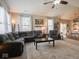 Comfortable living room features large windows, a plush sectional sofa, and a modern area rug at 9831 N Port Dr, McCordsville, IN 46055