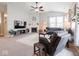 Spacious living room features a cozy fireplace, plush seating, vaulted ceilings, and a ceiling fan at 9831 N Port Dr, McCordsville, IN 46055