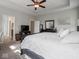 This bedroom has carpet flooring and includes a flatscreen television and a large bed at 9831 N Port Dr, McCordsville, IN 46055