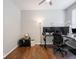 Spacious home office featuring hardwood floors and contemporary setup with a multiple monitor computer workstation at 9831 N Port Dr, McCordsville, IN 46055
