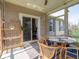 Relaxing enclosed sunroom with comfortable seating and a view of the outdoors at 9831 N Port Dr, McCordsville, IN 46055