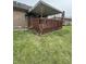 View of backyard showing elevated wooden deck, with brown railing at 1010 Pamela Dr, Plainfield, IN 46168