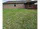 View of the backyard featuring a well-maintained lawn and a covered patio deck at 1010 Pamela Dr, Plainfield, IN 46168