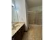 Bathroom with large mirror, vanity, shower with sliding glass doors, and patterned floor at 1010 Pamela Dr, Plainfield, IN 46168