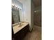 Bathroom with large mirror, vanity and countertop, shower, and patterned floor at 1010 Pamela Dr, Plainfield, IN 46168