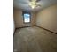 Bedroom with carpet, window, and ceiling fan, creating a comfortable and inviting atmosphere at 1010 Pamela Dr, Plainfield, IN 46168