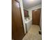 The laundry room has a washer, dryer, storage cabinets, and tile flooring at 1010 Pamela Dr, Plainfield, IN 46168