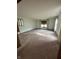 A bright living room with carpet, access to the kitchen and a large window at 1010 Pamela Dr, Plainfield, IN 46168