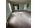 An open living area with access to the kitchen and sliding glass doors to a deck at 1010 Pamela Dr, Plainfield, IN 46168