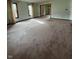 Expansive living room with neutral walls, plush carpeting and large windows at 1010 Pamela Dr, Plainfield, IN 46168