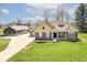 Charming front exterior featuring a well-manicured lawn, an attached three car garage, and a large storage building at 10151 E 191St St, Noblesville, IN 46060