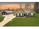 Charming front exterior featuring a well-manicured lawn, an attached three car garage, and a large storage building at 10151 E 191St St, Noblesville, IN 46060