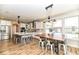 Well-lit kitchen boasts an expansive island, stainless appliances, and a dining table by large windows at 10151 E 191St St, Noblesville, IN 46060