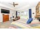 Comfortable main bedroom featuring ample natural light, ceiling fan, and decorative wood accent wall at 10151 E 191St St, Noblesville, IN 46060