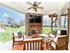 Relaxing outdoor patio with a brick fireplace, ceiling fan, comfortable seating and views of the open yard at 10151 E 191St St, Noblesville, IN 46060