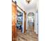 Pantry with sliding barn door reveals ample shelving and organization, offering a view into the kitchen at 10151 E 191St St, Noblesville, IN 46060