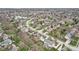 Residential area aerial showcasing the community with lush trees, landscaping, and a pond enhancing the neighborhood's appeal at 10157 Woods Edge Dr, Fishers, IN 46037