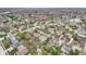 This aerial showcases lush trees, manicured lawns, and a pond offering a serene and picturesque living environment at 10157 Woods Edge Dr, Fishers, IN 46037
