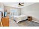 Bedroom with a large window, ceiling fan, and a dresser with a TV on top at 10157 Woods Edge Dr, Fishers, IN 46037