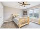 Bedroom featuring a ceiling fan, large window, and shelving on the wall at 10157 Woods Edge Dr, Fishers, IN 46037