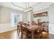 Inviting dining room with a wooden table, large windows, and a decorative chandelier at 10157 Woods Edge Dr, Fishers, IN 46037