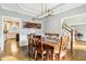 Elegant dining room with a large wooden table, stylish lighting, and hardwood floors at 10157 Woods Edge Dr, Fishers, IN 46037