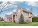 A two-story brick home with a side-entry garage sits on a lush green lawn with mature landscaping at 10157 Woods Edge Dr, Fishers, IN 46037