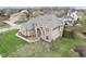 Aerial view of a brick home featuring an arched entrance, blue door, and manicured lawn at 10157 Woods Edge Dr, Fishers, IN 46037