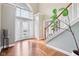 The foyer features hardwood floors, a staircase, a plant, and a large arched window at 10157 Woods Edge Dr, Fishers, IN 46037