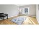 Bright living room with hardwood floors, a large window, and a decorative blue rug at 10157 Woods Edge Dr, Fishers, IN 46037