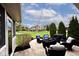 Backyard patio area with outdoor seating and lovely green lawn at 10234 Leeward Blvd, Indianapolis, IN 46256