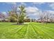 Expansive backyard with meticulously striped lawn, offering ample space for outdoor activities and relaxation at 10234 Leeward Blvd, Indianapolis, IN 46256