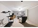 Finished basement with gray carpet, chair, ceiling fan, painted brick accent wall, treadmill and entertainment area at 10234 Leeward Blvd, Indianapolis, IN 46256