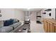 Finished basement features gray carpet, painted brick accent wall, and comfortable seating area at 10234 Leeward Blvd, Indianapolis, IN 46256