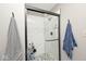Bathroom with modern shower, sleek glass doors, and stylish tile at 10234 Leeward Blvd, Indianapolis, IN 46256