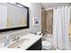 Bathroom with white vanity, tub and shower with beige tile surround at 10234 Leeward Blvd, Indianapolis, IN 46256