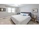 Bedroom features a comfortable bed, window, and neutral walls at 10234 Leeward Blvd, Indianapolis, IN 46256