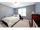 Modern bedroom with a large window, bed, and sleek decor at 10234 Leeward Blvd, Indianapolis, IN 46256